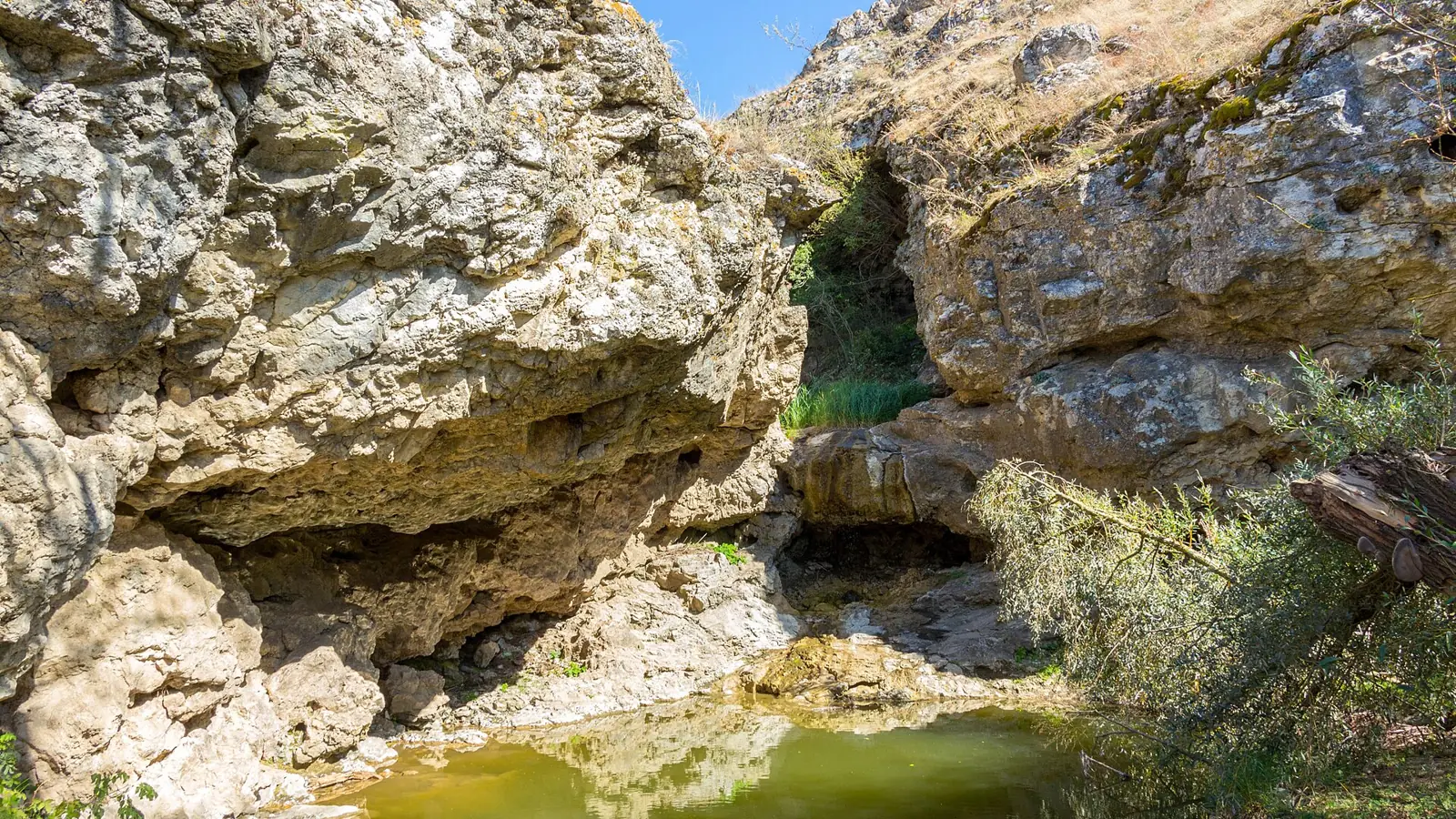 The Snakes' Waterfall running between the limestone walls of the Varatic Gorge
